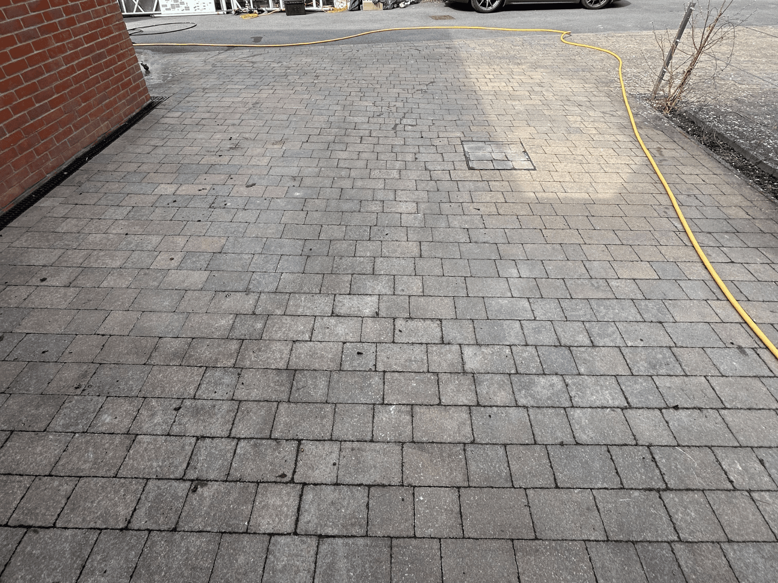 Red block paving driveway before cleaning